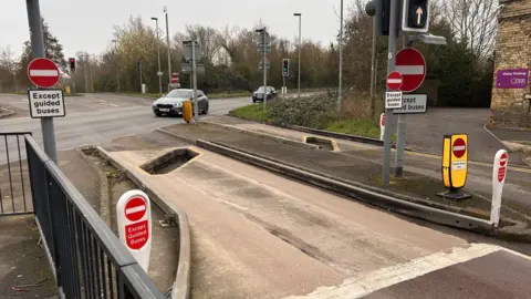 St Ives guided busway car trap is a diagonal hole on the road and has multiple no entry signs around on posts around it.