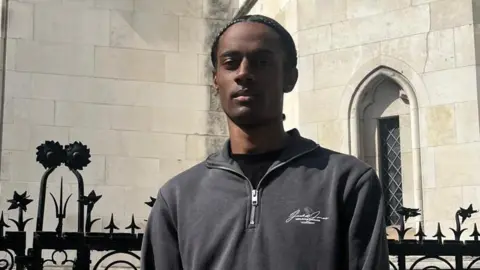 Daryl McLune wearing a grey hoodie outside Central London County Court