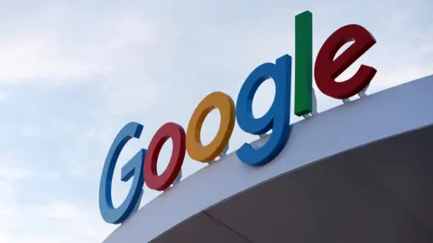 A sign is above a building which says Google. The letters are blue, red, orange and green.