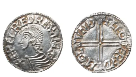 Colchester and Ipswich Museum Service Two views of a silver penny of Etheldred II, king of England, from AD978 to 1016. The view on the has a profile portrait of the king with a mass of hair like a long Mohican and wearing a tunic, pinned at the throat and he appears to be smiling. His name is struck on its circumference. The right view is of a simple cross with the name of the maker and its date on its circumference.