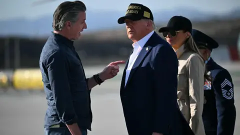 Man points at man while speaking