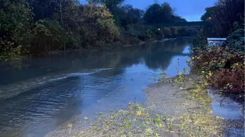 Network Rail Flood water is covering the railway tracks.