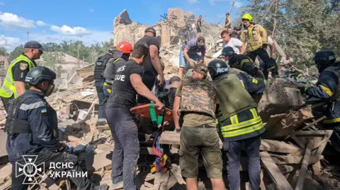 Ukraine's state DSNS emergency service Rescuers search through the rubble after a Russian missile strike in Kryvyi Rih, southern Ukraine. Photo: 12 June 2024