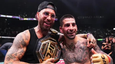 Ilia Topuria celebrates with Sergio Ramos after beating Max Holloway at UFC 308 in Abu Dhabi