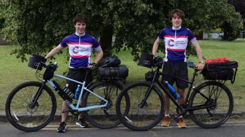 Sam and Josh Harwood-White in cancer research outfits with their bikes