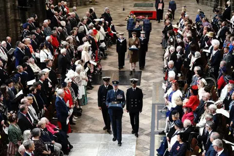 Aaron Chown/PA Media Artefacts from the Second World War are processed through Westminster Abbey in London during the Service of Thanksgiving on the 80th anniversary of VE Day