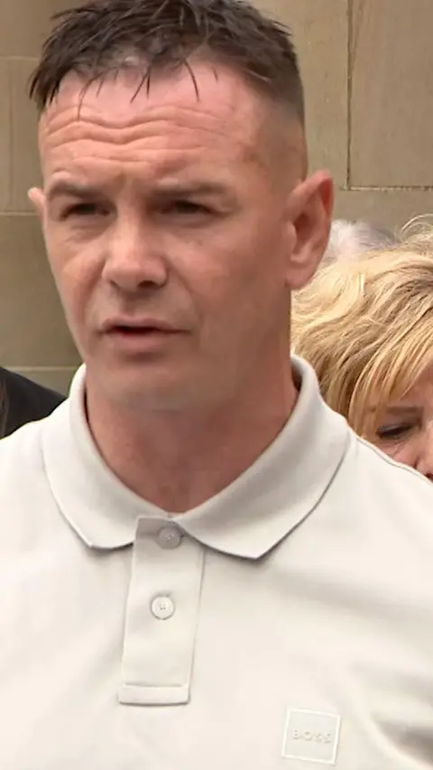 Man with white polo and dark hair