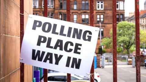 A sign that reads 'polling place way in' outside a polling station in Glasgow