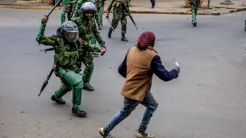 Riot police apprehend during a demonstration against a proposed finance bill on July 16, 2024 in Nairobi, Kenya