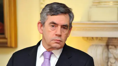 PA Media Gordon Brown listens carefully during a press conference at Downing Street in 2008