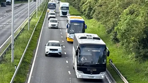 Kevin Shoesmith/BBC Coaches travel along a busy dual carriageway 