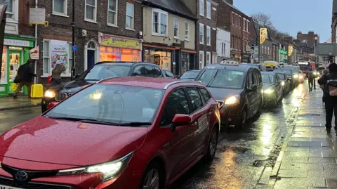 Naj Modak/BBC Stream of cars on Gillygate in York