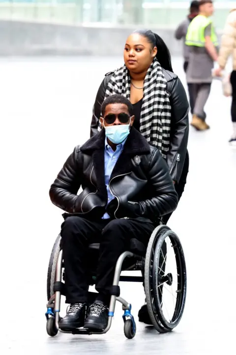 PA Media Jordan Walker-Brown, 23, arrives at court in a wheelchair on 2 May.
