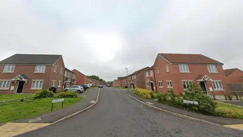 Google Street view of a street lined by two-storey red brick houses