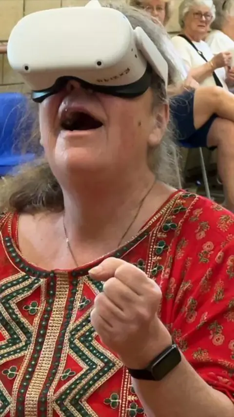 Woman smiling using a VR headset.