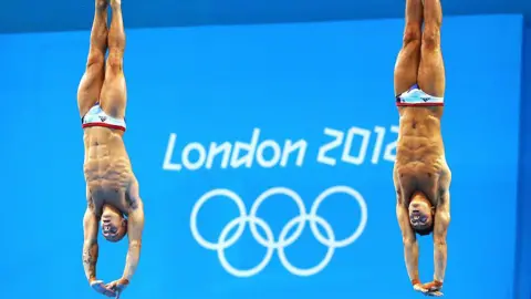 Getty Images Tom Daley (R) and Peter Waterfield (L) of Great Britain compete in the Men's Synchronised 10m Platform Diving