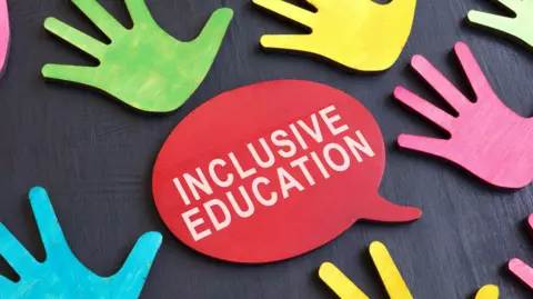 Getty Images Multi-coloured palm prints on a dark surface and an inscription which reads: Inclusive education