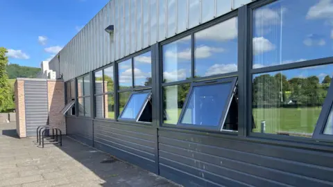 BBC The exterior of a leisure centre building with windows open