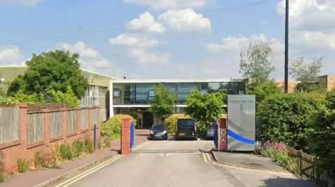 Google The entrance of a car park with a silver totem to the right hand side with the South Staffordshire College logo at the top
