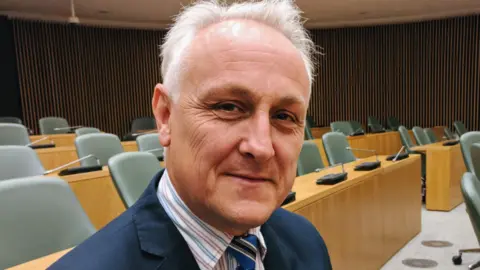Alan Graves sitting in city council chamber