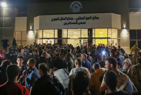 Getty Images People evacuated from Sudan arrive at a military airport in Amman on April 24, 2023