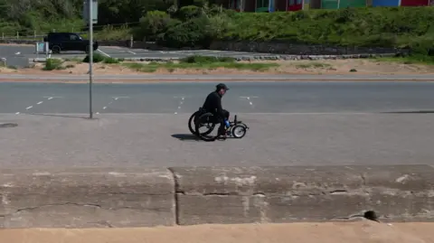 A drone picture of wheelchair athlete Lexi Chambers training for her challenge along the seafront in Exmouth.