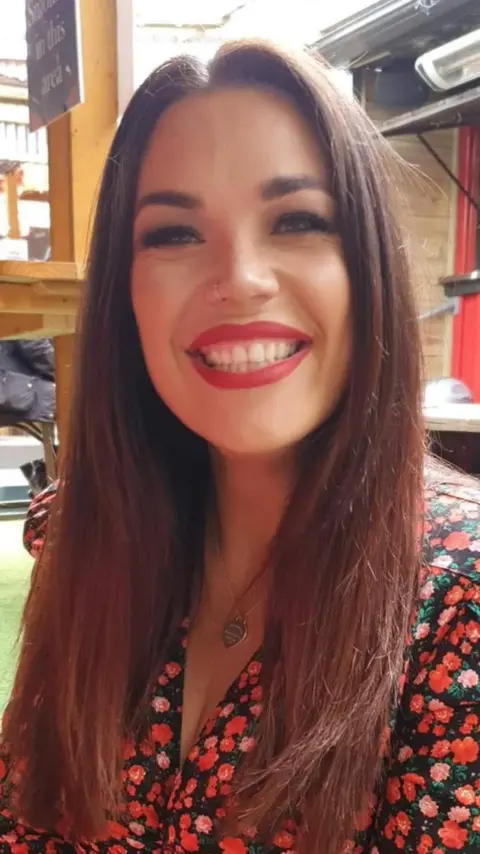 Hunt Family A young woman with long dark hair smiling at the camera