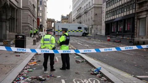 Reuters Forensic officers work near the site of an incident.