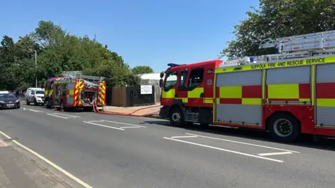 Alice Cunningham/BBC Two fire engines are parked on the road outside Sidegate Lane Primary School