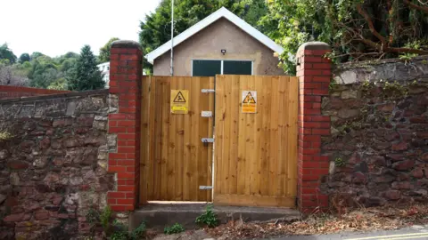 An energy  substation down  woody  locked doors connected  a street