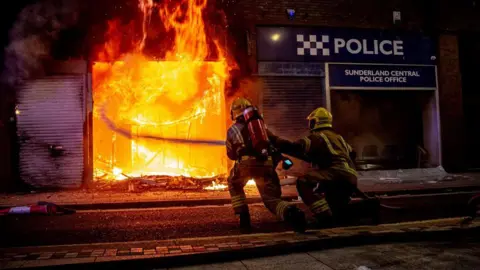 Getty Images A police office on fire in Sunderland 