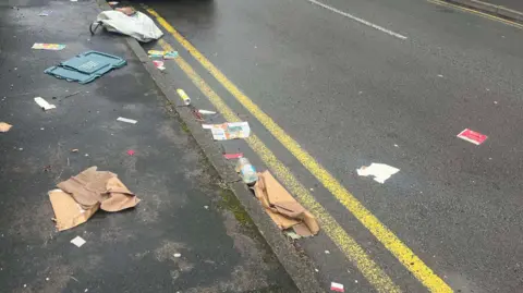 Rubbish strewn across a road