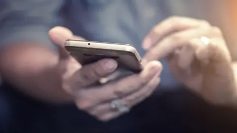 A person's hands using a smartphone