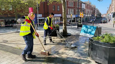 The Vale of Glamorgan Council's Highways Maintenance team, pressure washing a square in Barry