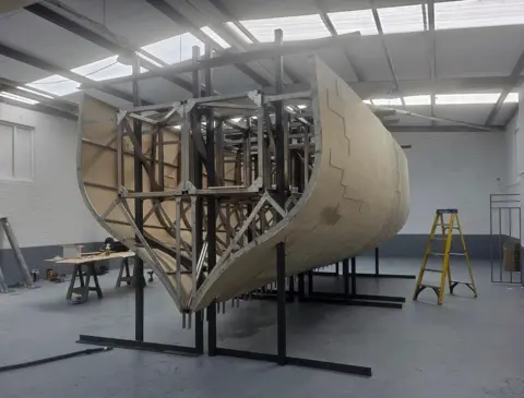 Aivaf A ship's hull with a stainless steel internal structure clad in a light brown outer shell