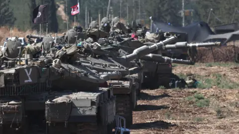 EPA Israeli tanks at a gathering point in northern Israel (28 September 2024)