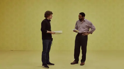 A24 Parsons on set discussing a scene with Ejiofor