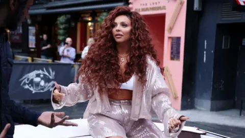 Jesy Nelson in a pink-sequinned top and shorts arrives at Global Radio Studios in Leicester Square