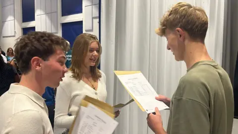 George Carden/BBC Students look at their GCSE results