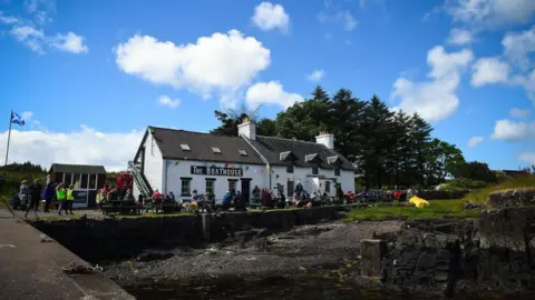 Getty Images The Boathouse pub/restaurant, a while walled building on the island docks. 