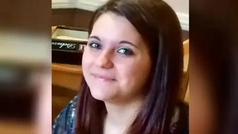 Davis family Laura Davis with long brown hair looking directly at the camera and smiling