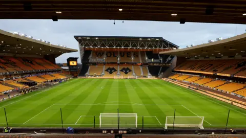 A view of an empty Molineux stadium and pitch taken from one of the stands behind one of the goals.