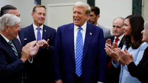 Reuters Republicans standing around Donald Trump applaud