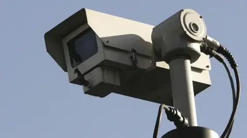 Getty Images A close up of a grey CCTV camera with blue sky in the background