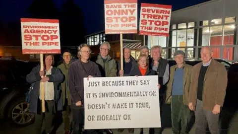 BBC Members of the Onny Preservation Group, environmentalists, anglers and land owners, holding placards protesting against the planned pipeline  

 