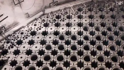 EDF A black and white image shows the tops of dozens of tube like structures, the graphite bricks. They are tightly packed together and there are ridges around each circle.