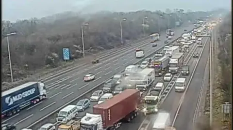 A view of the M25 clockwise carriageway. Lanes of backed up traffic are pictured.