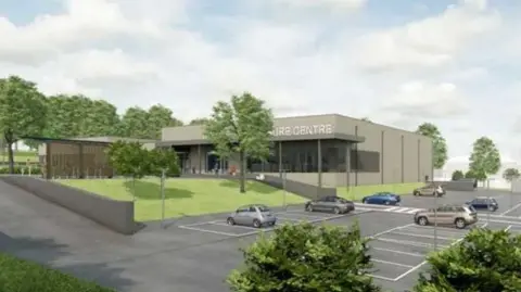 An artist's impression of a leisure centre building. The grey square building is shown sitting in a site surrounded by grass verges, trees and a car park.
