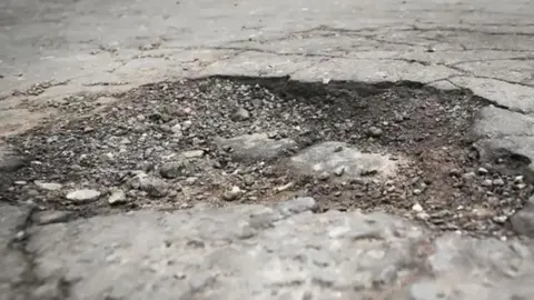 PA Media A large pothole in concrete