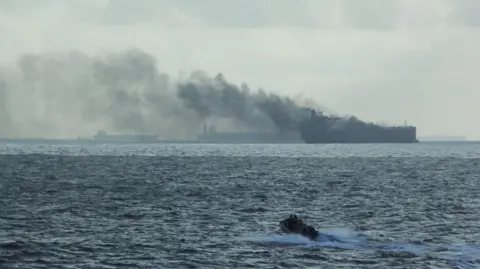 Reuters Rescue teams reach oil tankers on fire off the Singaporean island of Pedra Branca